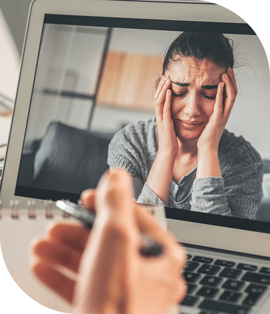 Video call therapy session with distressed woman.