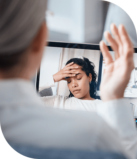 Video call showing stressed woman holding head.