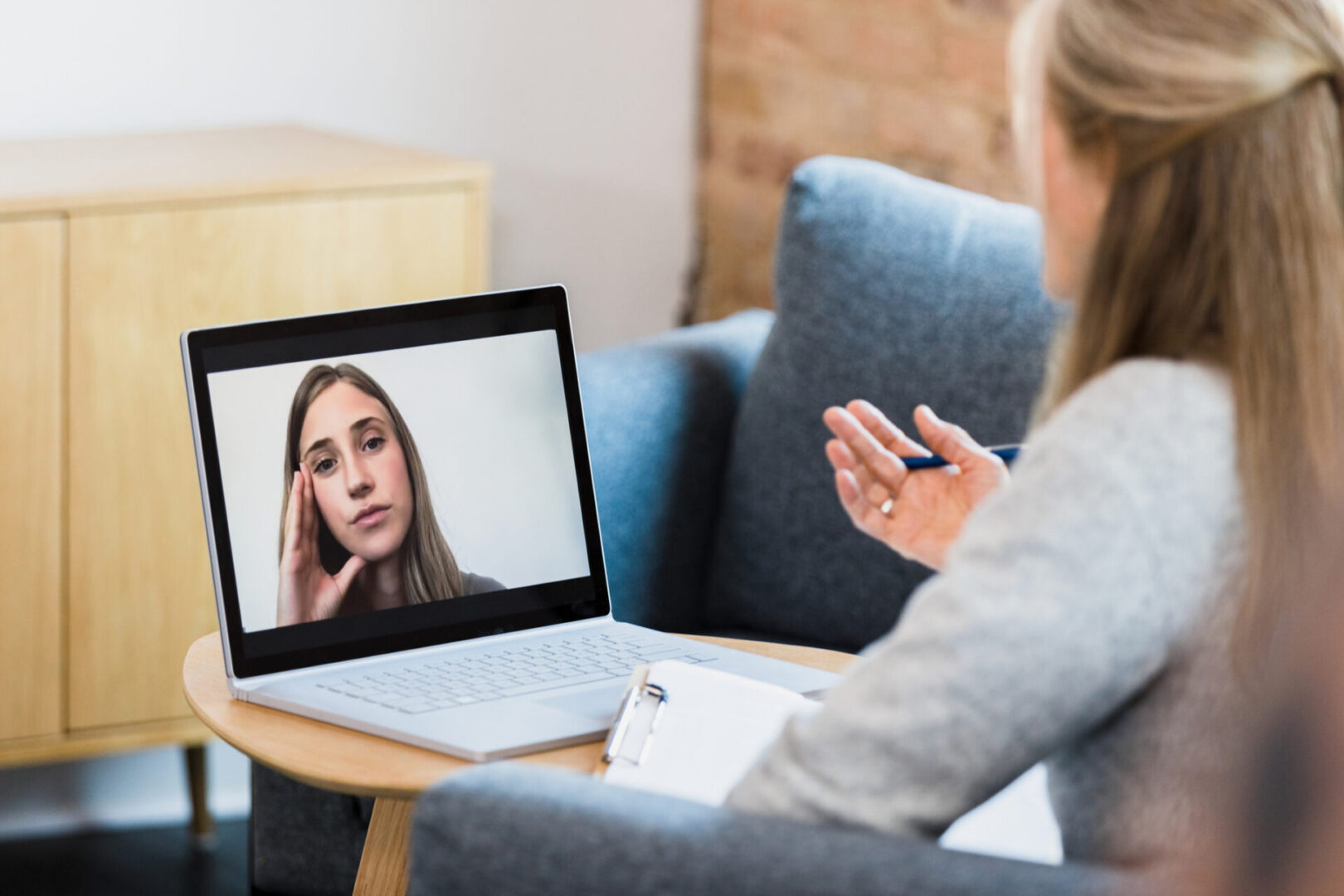 Video call between two women on laptop.