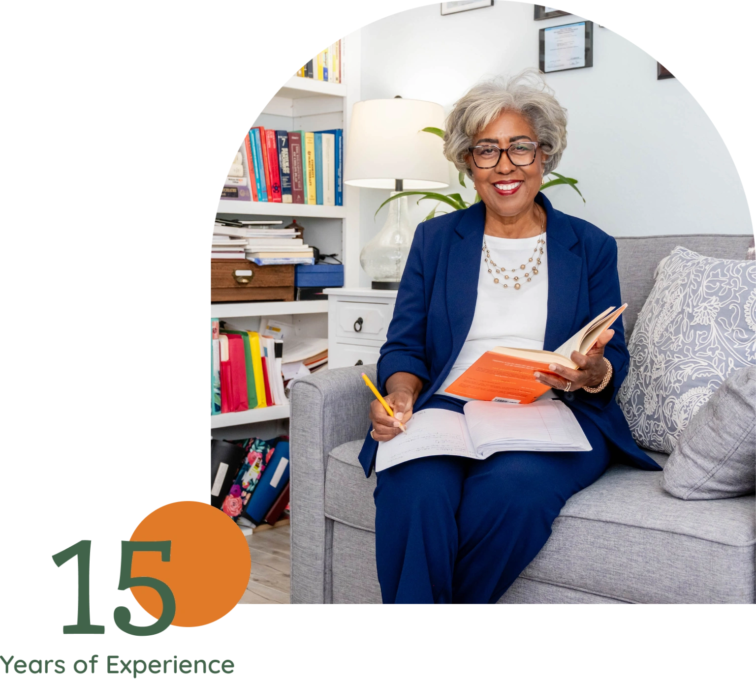Smiling professional woman reading on couch