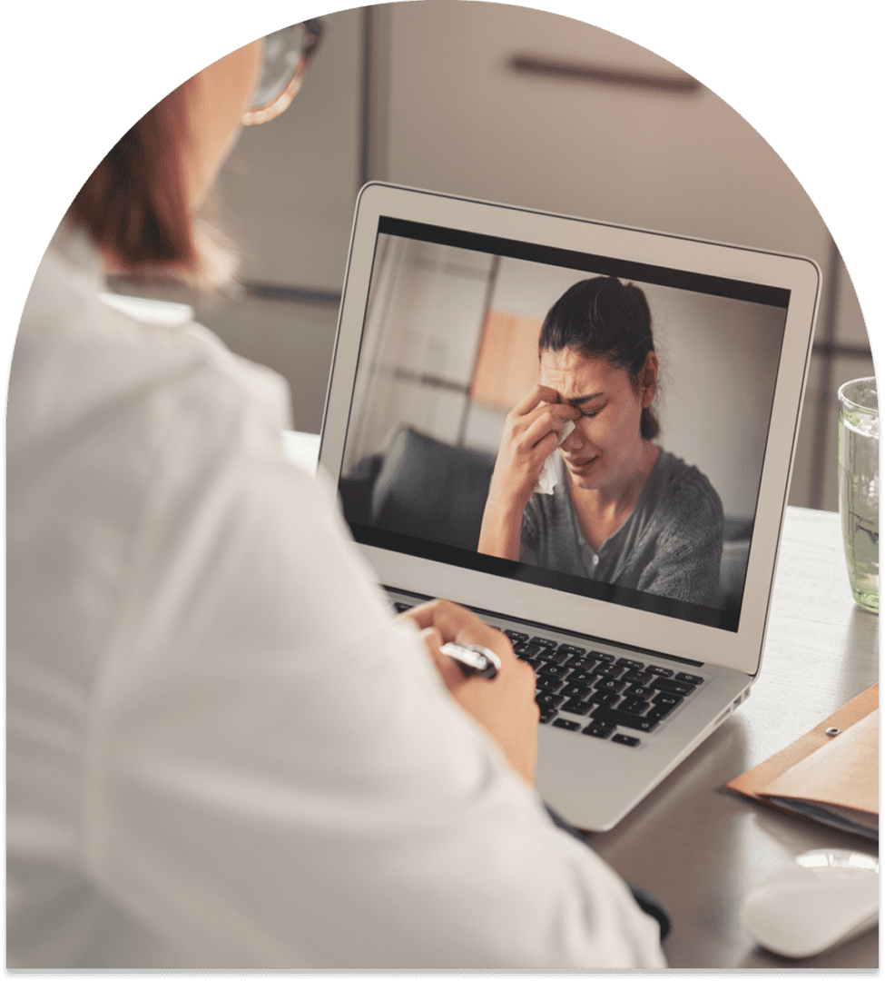 Telehealth consultation with distressed woman online.