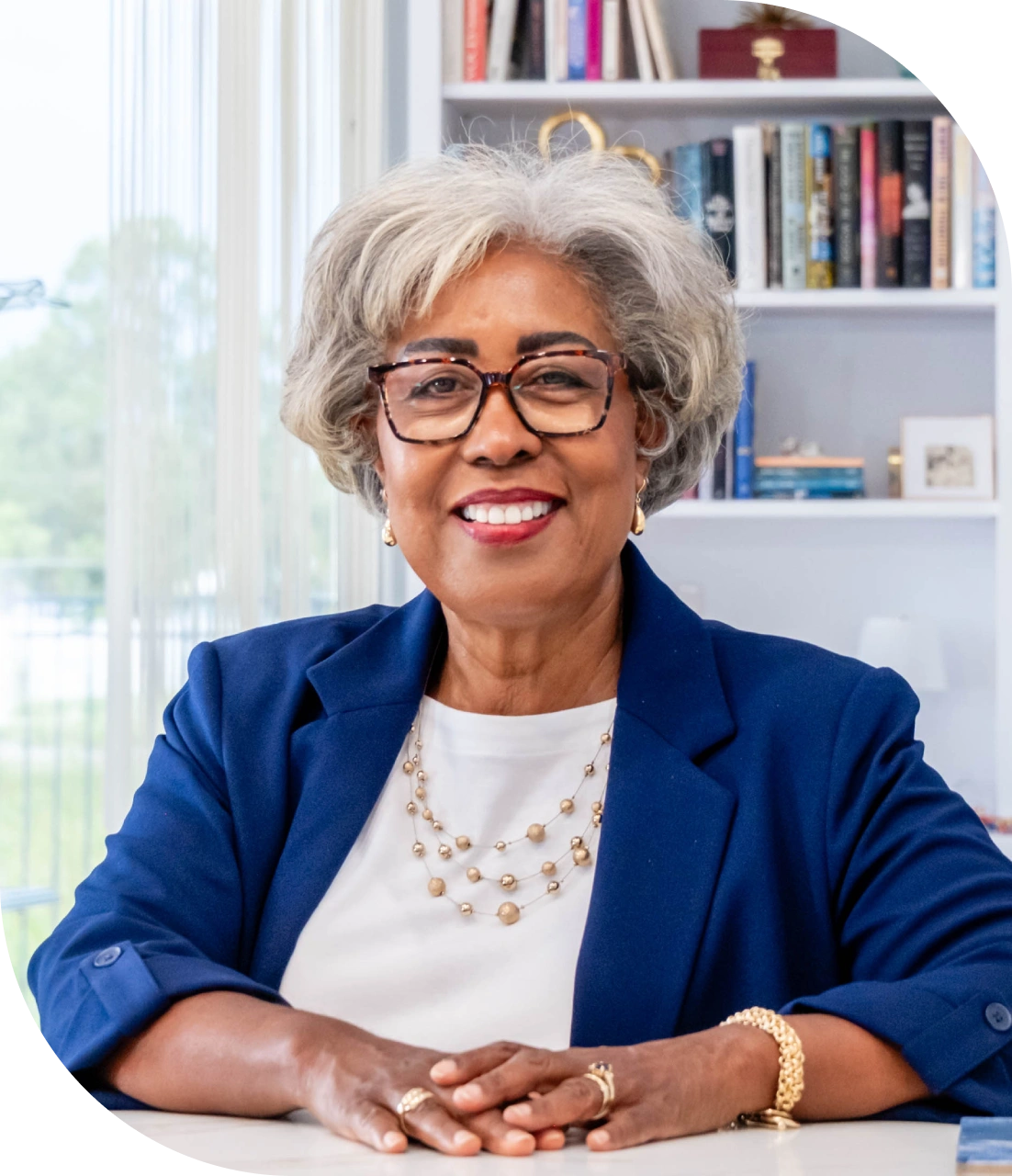 Smiling woman in blue blazer at desk
